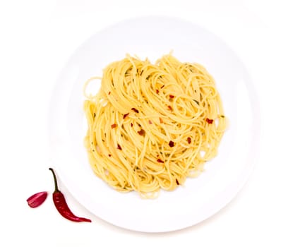 Spaghetti with garlic and chilli on a white background seen from above