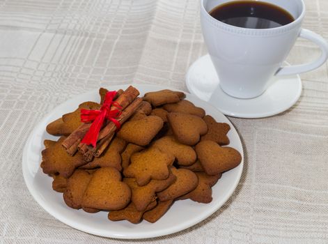 pepper cinnamon cookies in a dish on the background of a linen tablecloth and cap of coffee