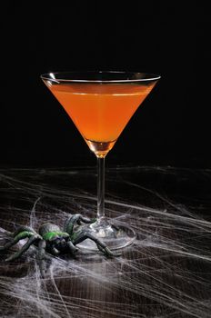 Orange cocktail in a glass on Halloween