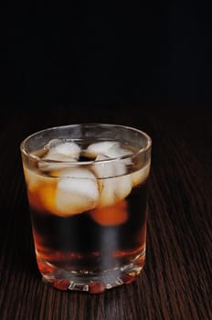 Glass of cola with ice on a table