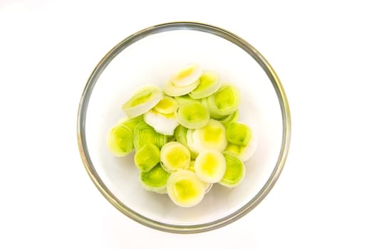 Bowl with sliced leek on a white background seen from above