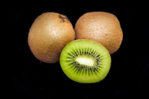 Fresh kiwi cut on a black background