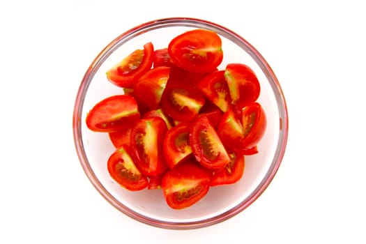 Slices of tomato on bowl on white background seen from above