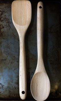Wooden spoons on a metal work surface.