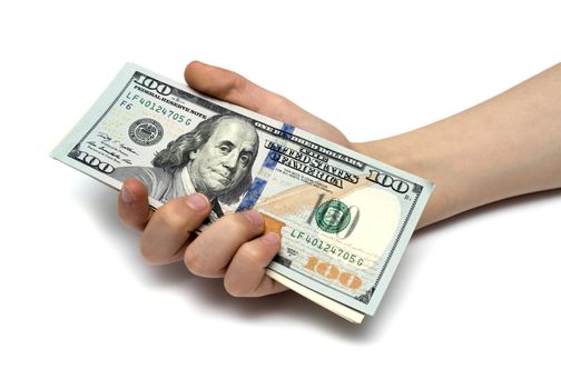 Child's hand and pile new cash U.S. dollars isolated on a white background