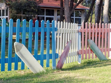 children playground surrounded with wooden colored fence