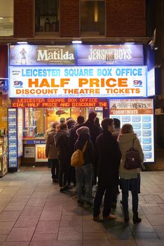 LONDON, UK - JANUARY 02: People lined up for discounted theatre tickets at night in Leicester Square. January 02, 2015 in London.