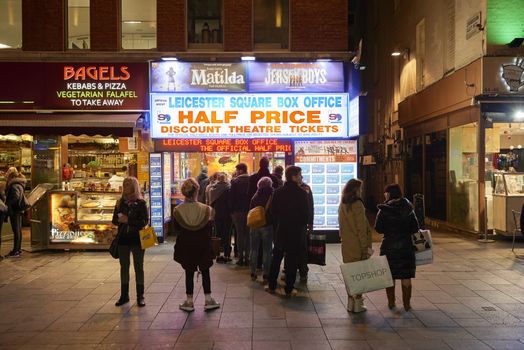LONDON, UK - JANUARY 02: People lined up for discounted theatre tickets at night in Leicester Square. January 02, 2015 in London.