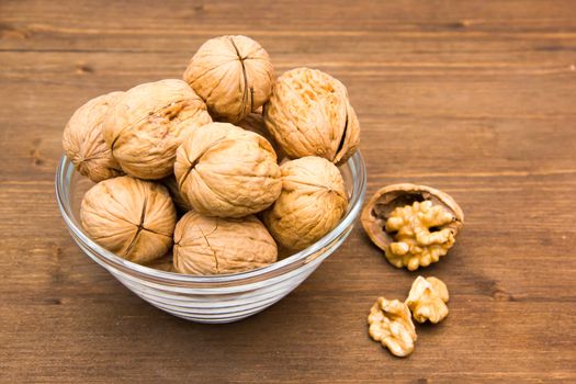 Nuts on glass bowl on wooden table