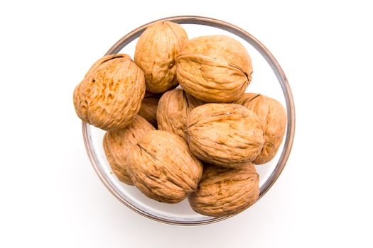 Nuts on bowl on white background seen from above