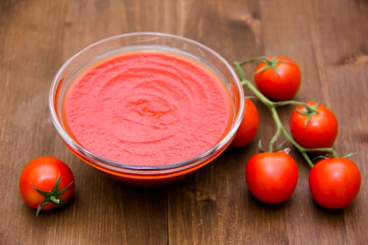 Tomato sauce on bowl on wooden table