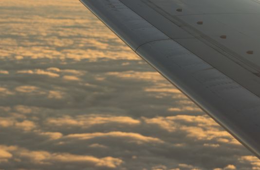 Airplane flying in sky in flight metal wing.