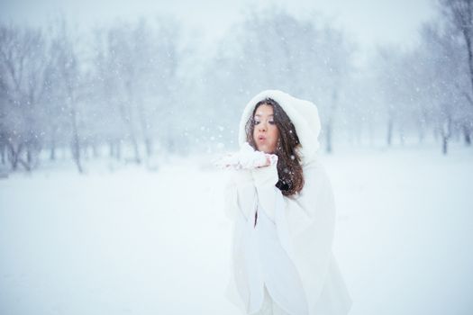 Girl enjoying the first snowflakes in late december