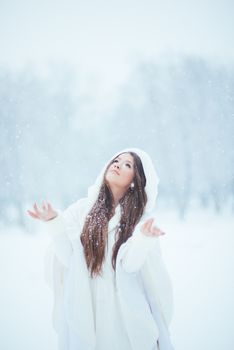 Girl enjoying the first snowflakes in late december