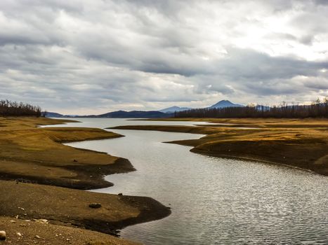 Plastiras lake view with dramatic cloudy sky, in central Greece