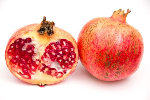 Fresh pomegranate seen up close on a white background