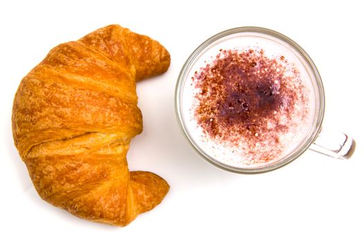 Cappuccino and croissant seen from above on white background