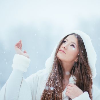 Girl enjoying the first snowflakes in late december