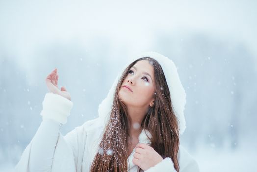 Girl enjoying the first snowflakes in late december