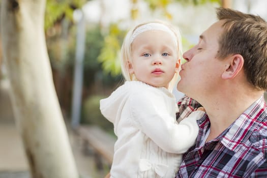 Adorable Little Girl with Her Daddy Portrait Outside.