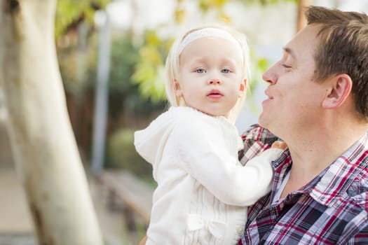 Adorable Little Girl with Her Daddy Portrait Outside.