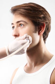 Handsome man during microdermabrasion treatment in beauty salon