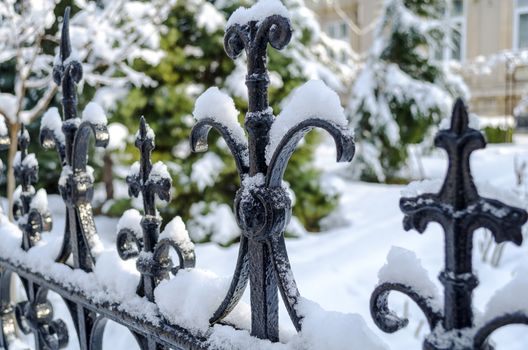 Snow cover rusty old fence closeup view