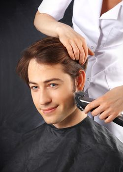 Portrait of a young white boy while cutting hair in the hair salon