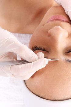 Caucasian woman during surgery using a scalpel