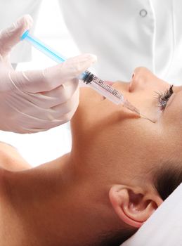 Caucasian woman during surgery using a scalpel