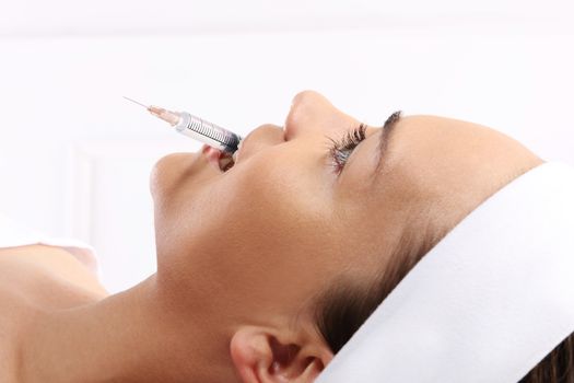 Portrait of a white woman during surgery filling facial wrinkles, Cosmetic is injected into facial skin cosmetics