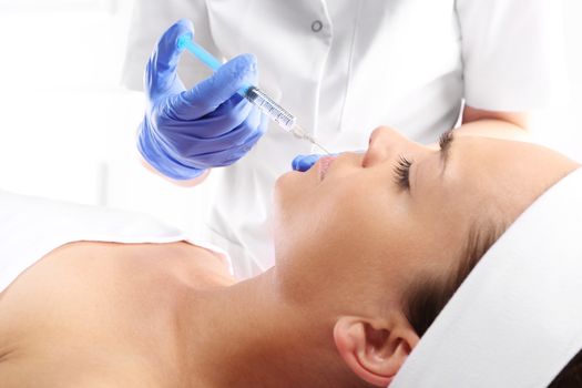 Portrait of a white woman during surgery filling facial wrinkles, Cosmetic is injected into facial skin cosmetics