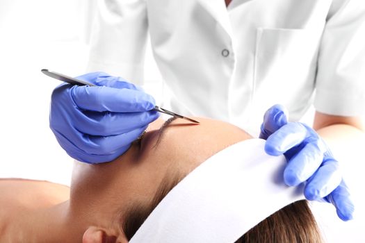 Caucasian woman during surgery using a scalpel