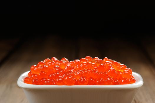 Red caviar in white bowl closep macro