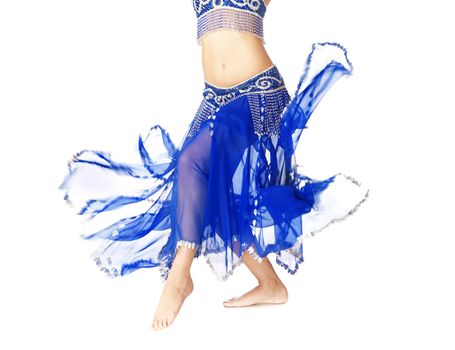 Belly dancer in blue traditional dress on a white background