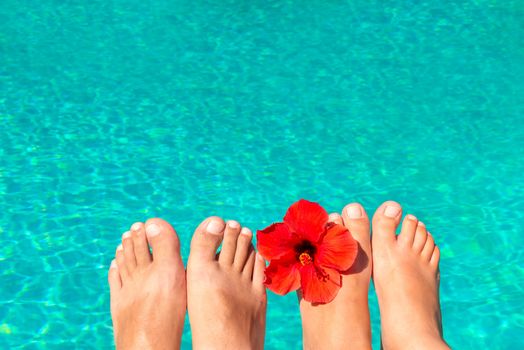 macro picture the newlyweds feet by the pool with flower