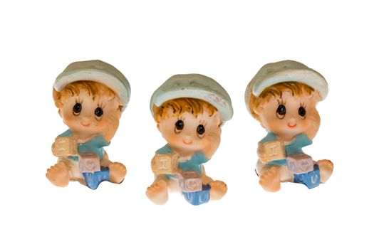 three children made of porcelain on white background