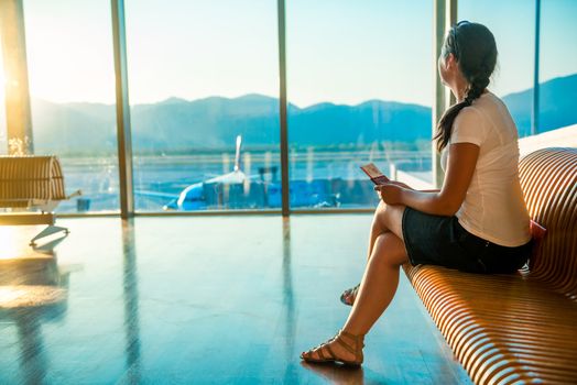 woman at the airport with a ticket waiting for departure