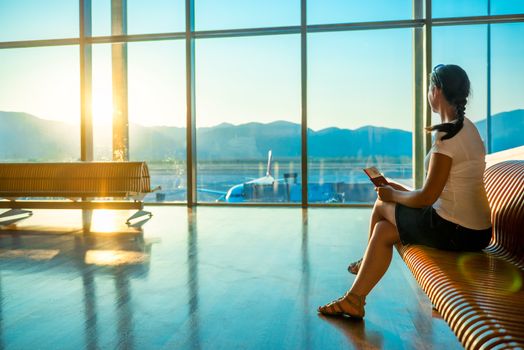 girl at the airport waiting for boarding