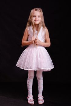 Portrait of a beautiful five year old girl on a black background