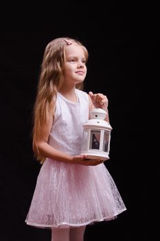 Five year old girl standing with a candlestick