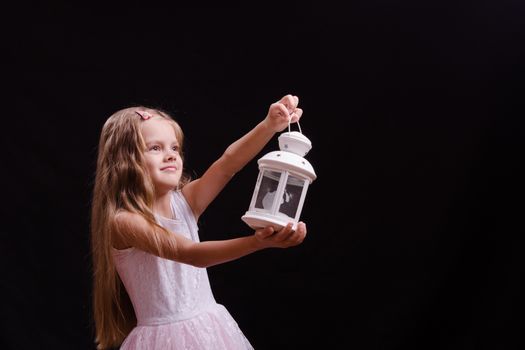 Five year old girl standing with a candlestick