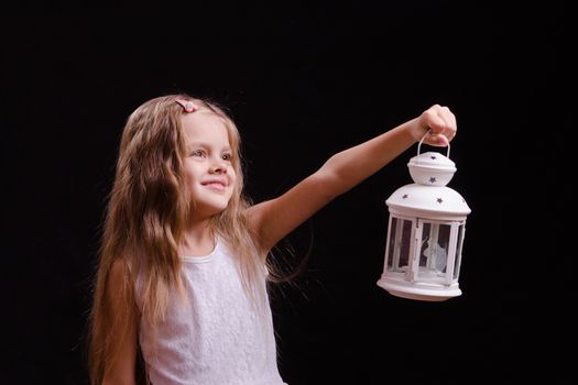 Five year old girl standing with a candlestick