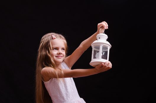 Five year old girl standing with a candlestick