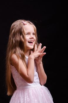 Portrait of a beautiful five year old girl on a black background