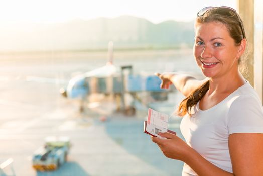 girl on the background plane at the airport