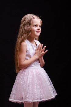 Portrait of a beautiful five year old girl on a black background