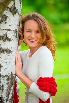 portrait of a beautiful girl in spring park near birch