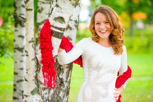 cheerful and beautiful girl in a dress in the spring park