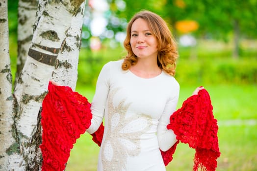 young beautiful woman posing in a summer park